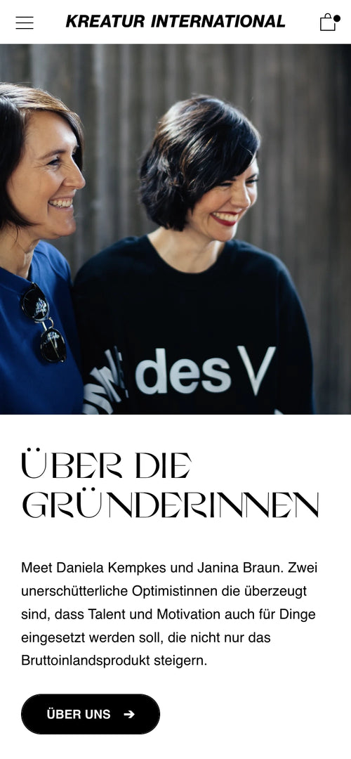 Zwei lächelnde Personen in schwarzen Oberteilen. Abschnitt über Gründerinnen von Kreatur International.