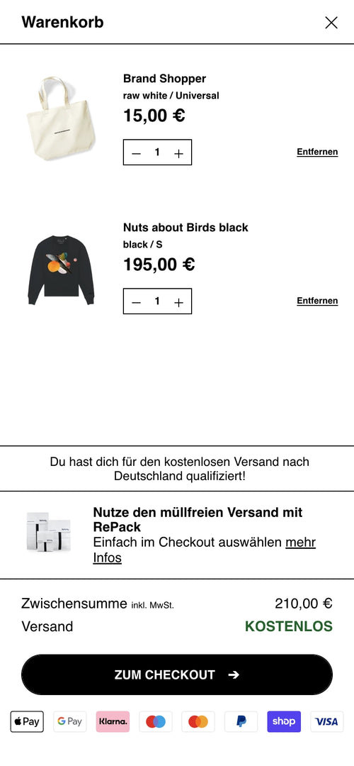 Warenkorb zeigt Shopper und Sweatshirt mit Preisen, kostenloser Versand ausgewählt.