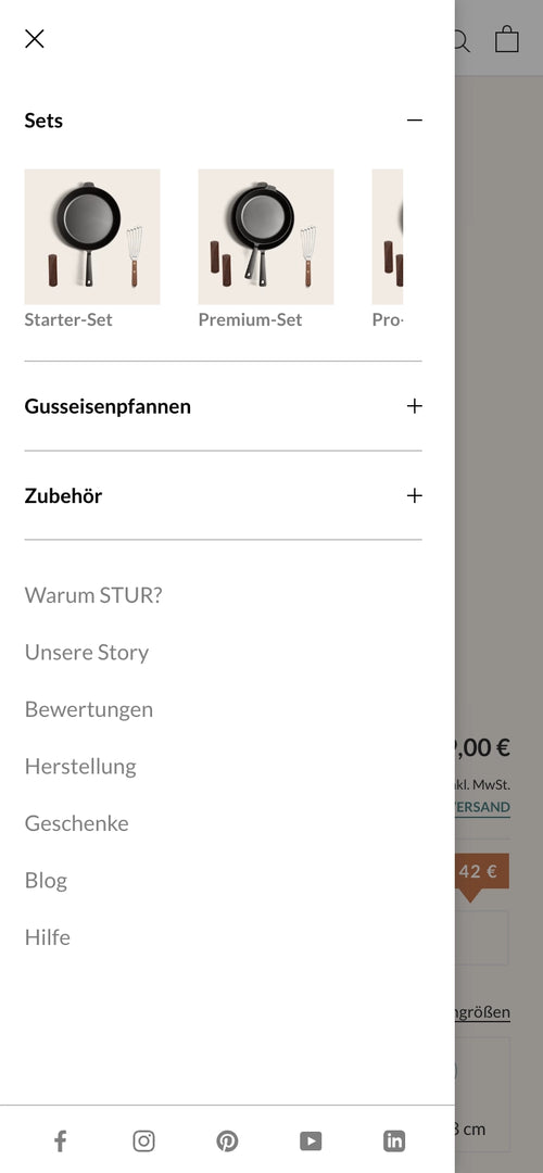 Seitliches Menü mit Sets, Gusseisenpfannen, Zubehör, und weiteren Kategorien.