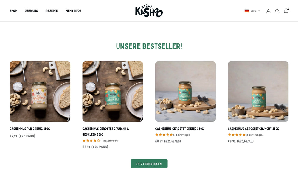 Vier Gläser Cashewmus auf Holztisch mit Text 'UNSERE BESTSELLER!' oben.