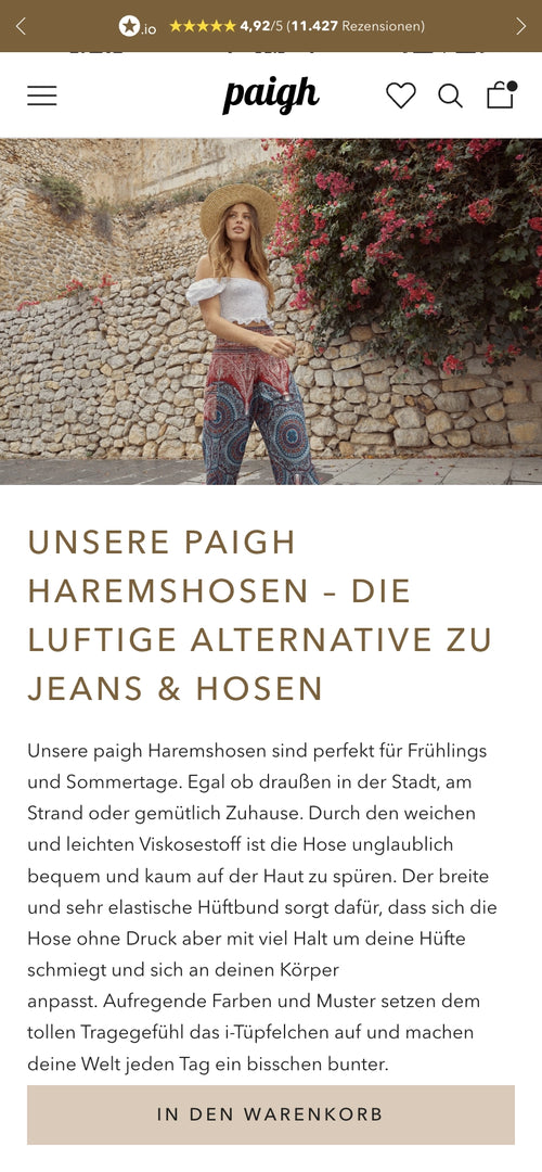 Frau in gemusterter Haremshose und Strohhut steht vor Steinhintergrund, Text über Haremshosen.