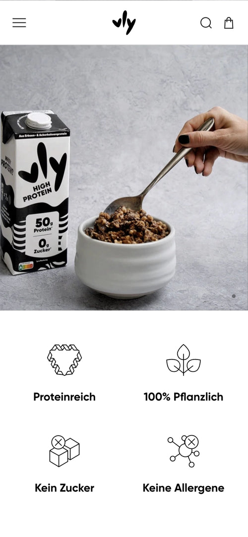 Schwarze Vly-Verpackung neben einer Schüssel Müsli, Hand löffelt Müsli.